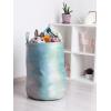 Ambesonne Christmas Laundry Bag, Xmas Town with Buildings and Winter Season Snowing Landscape Illustration, Hamper Basket with Handle Drawstring Closure for Laundromats, 13″ x 19″, Pale Blue Pearl(Pale Sky Blue Fern Green)
